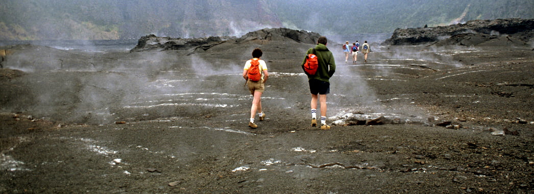 AKRWFK Hikers wander through lava flows in Kilauea Iki volcano in Hawaii Volcanoes National park. Image shot 2006. Exact date unknown.