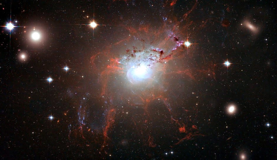 IN SAPCE - UNDATED - This handout image of the giant, active galaxy NGC 1275, obtained August 21, 2008 was taken using the NASA/ESA Hubble Space Telescope’s Advanced Camera for Surveys in July and August 2006. It provides amazing detail and resolution of fragile filamentary structures, which show up as a reddish lacy structure surrounding the central bright galaxy. These filaments are cool despite being surrounded by gas that is around 55 million °C. They are suspended in a magnetic field which maintains their structure and demonstrates how energy from the supermassive black hole hosted at the centre of the galaxy is transferred to the surrounding gas. (Photo by NASA/ESA via Getty Images)